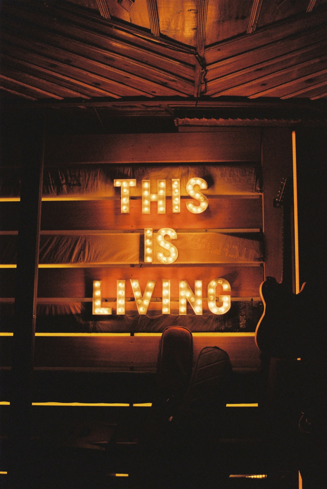 a neon sign that says this is living