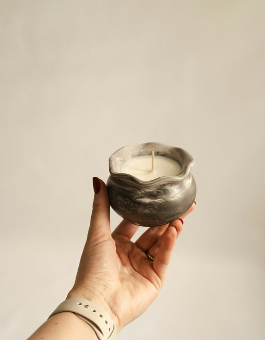 A person holding a candle in their hand