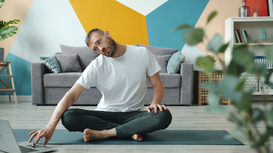 Man doing neck stretches on yoga mat at home
