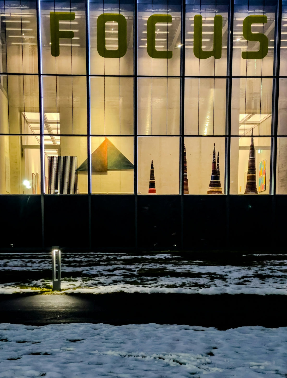 Building with large focus sign at night