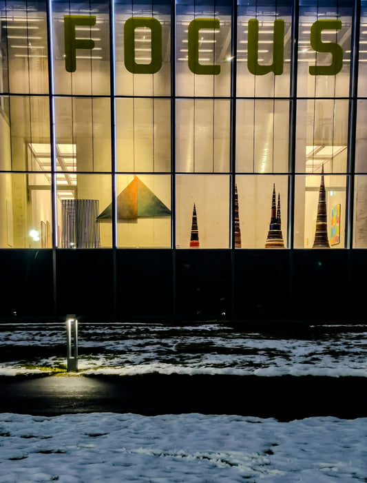 Building with large focus sign at night